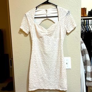 Cream dress, short, zip up in the back, with a circle open area in the back